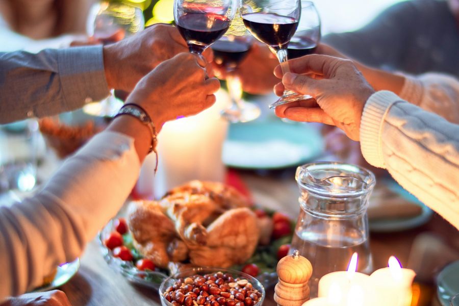 Attain on 5th apartment homes with Musician playing electric guitar and singing on stage in a lively, crowded bar with warm lighting.